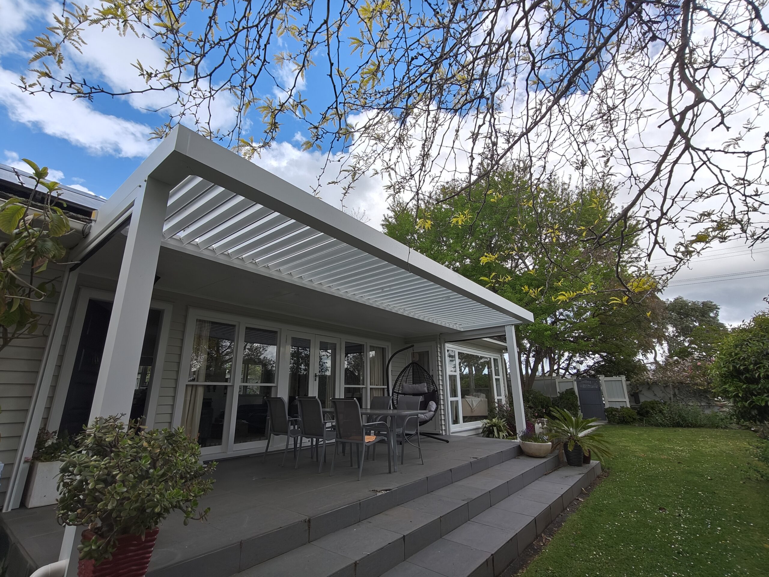 Wide-span custom pergola with minimal support posts